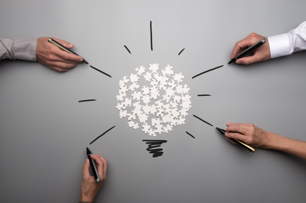 top-view-white-scattered-puzzle-pieces-businesspeople-hands_254268-674